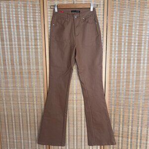 Hotkiss tan high rise flare pants that have a faux leather look to them